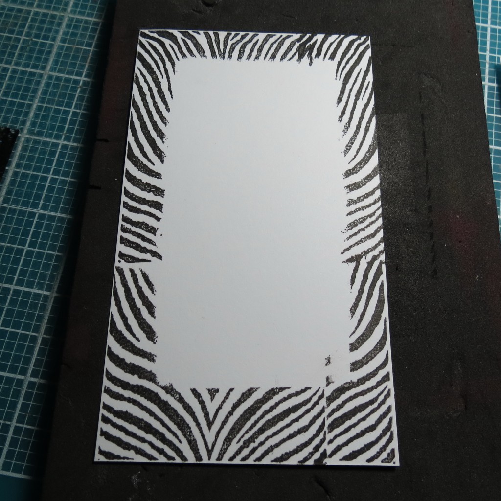 using a scrap paper to create a mask, stamp around the edges for a matching border