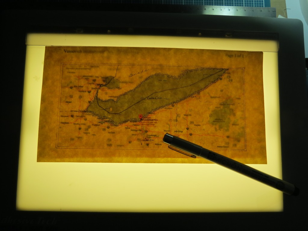 Scrapbook Pages Inspired by Treasure Island: parchment over printed map using light box for general outline.