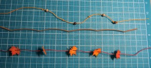 Fall Flourish #1 Border arranging strands of leaves, beads and leather  to weave into border.