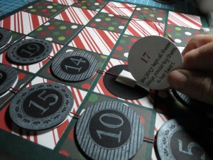 Countdown to Christmas: fitting the story disc to the backside of the date tag.