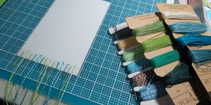 Baby Shower Scrapbook Ideas: Using twine and cording to create a unique backdrop for this block tile.